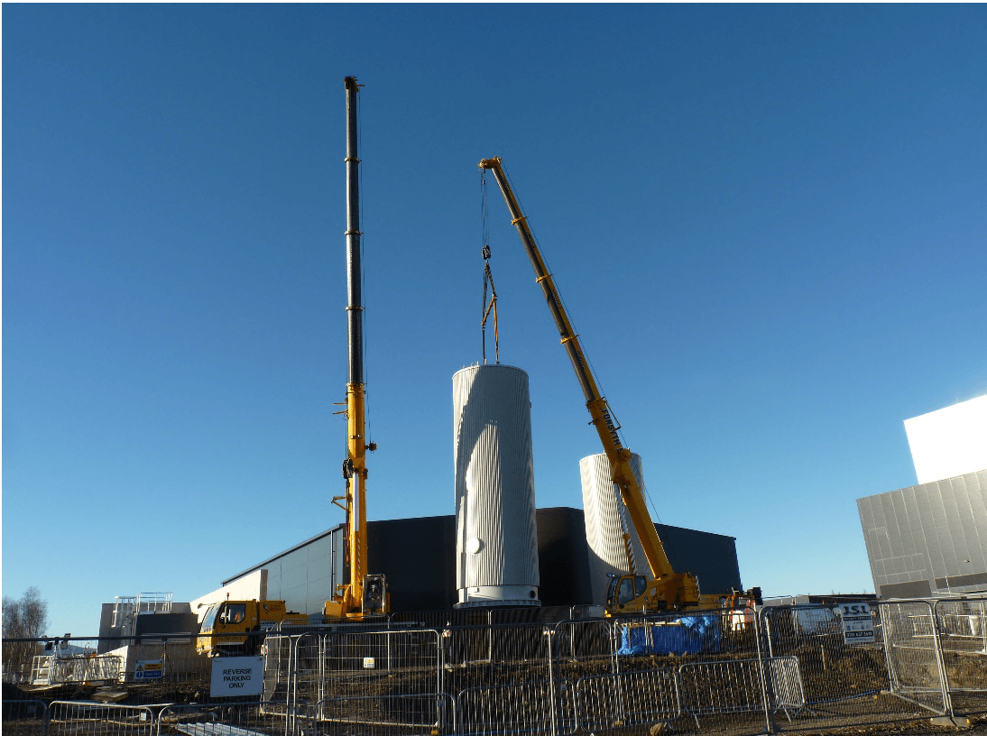 A crane lifting a cylindrical object