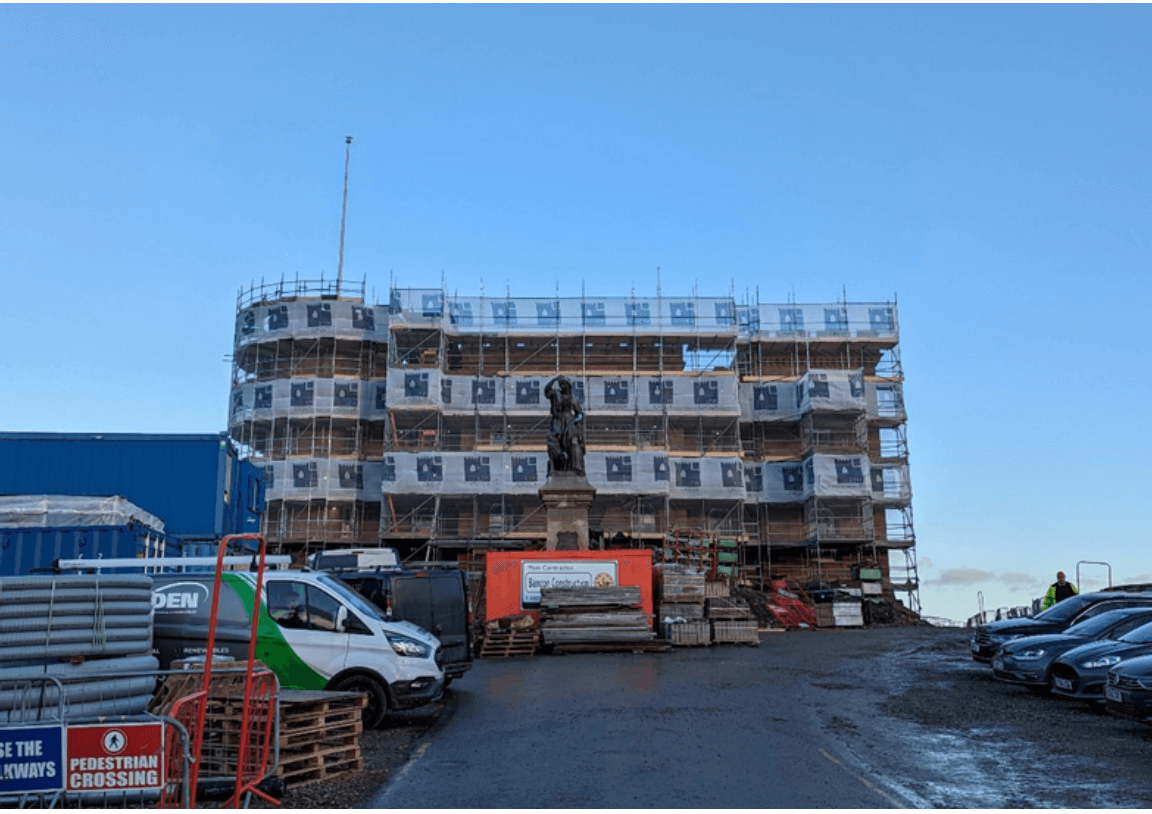 Inverness Castle council administration building under construction with a statue in front.