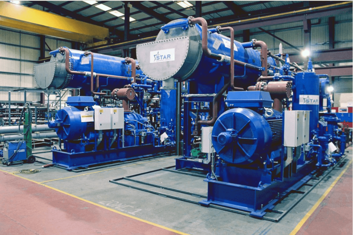 Large, blue water source heat pump equipment in the energy centre room at Queen's Quay.