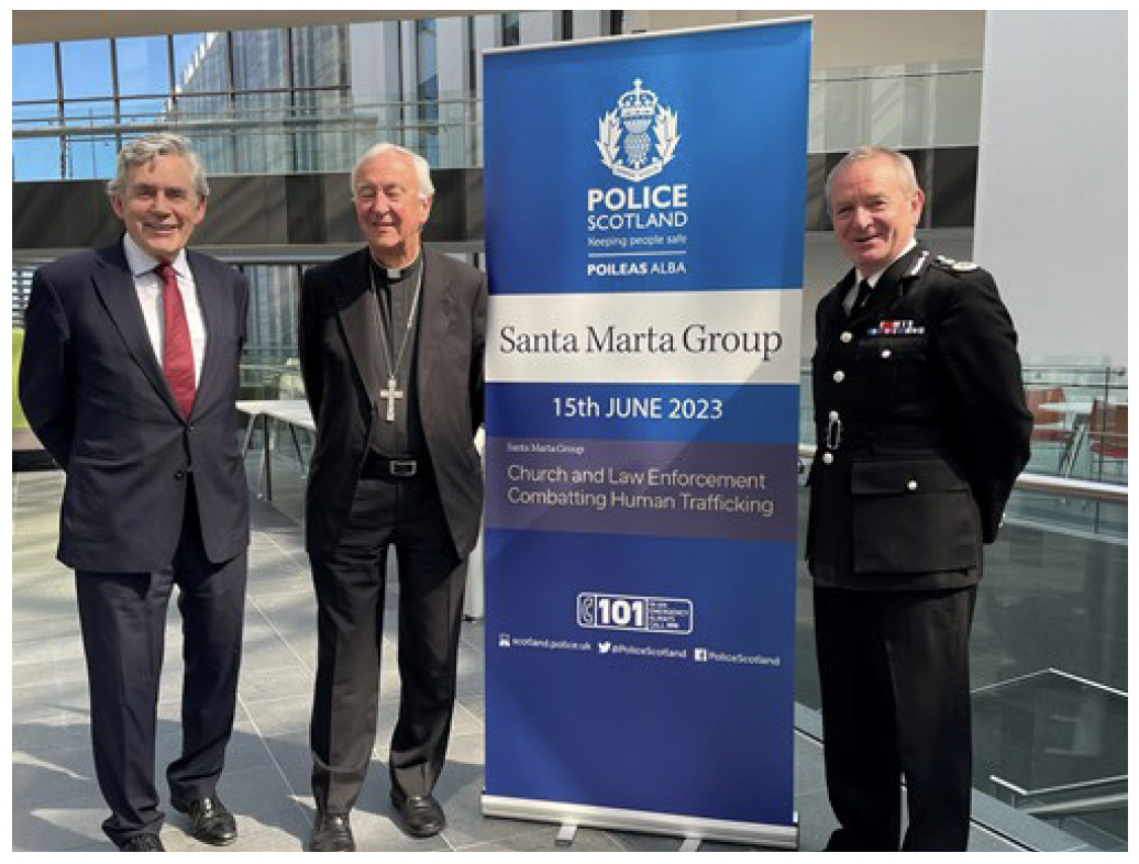 Picture of Police Scotland's ex chief constable, Gordon Brown and priest at the trafficking summit hosted by Police Scotland.