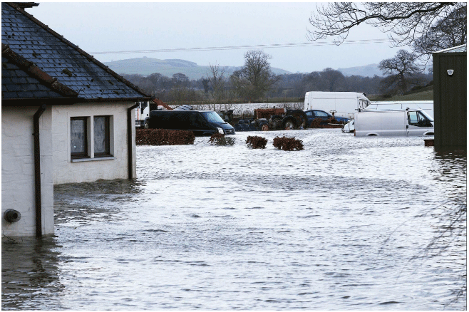 A flooded house and cars in Carnsalloch.