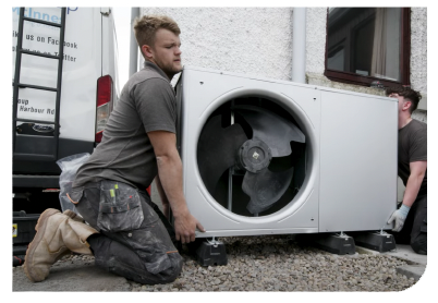 Case study: Two workers installing a heat pump outside a house